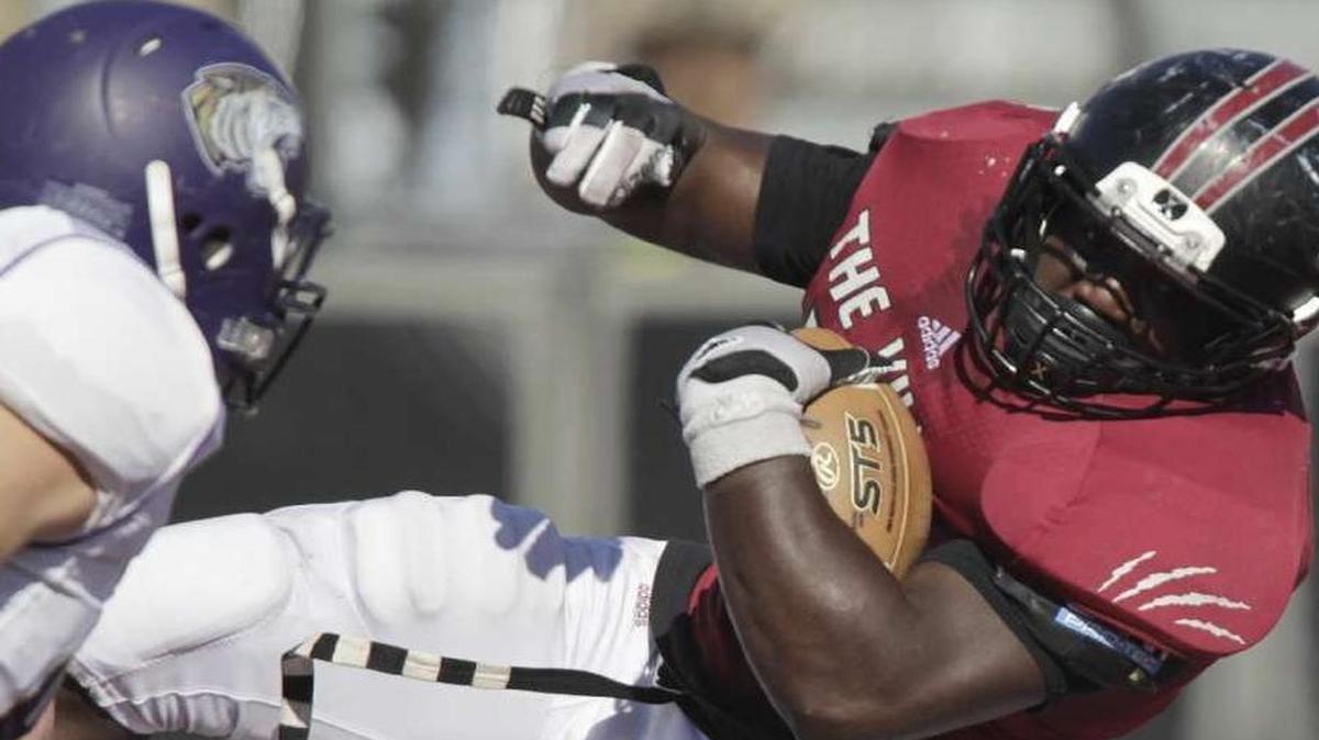 
Lindenwood-Belleville runningback Kam Harris rolls over the back of an opposing player last season.

