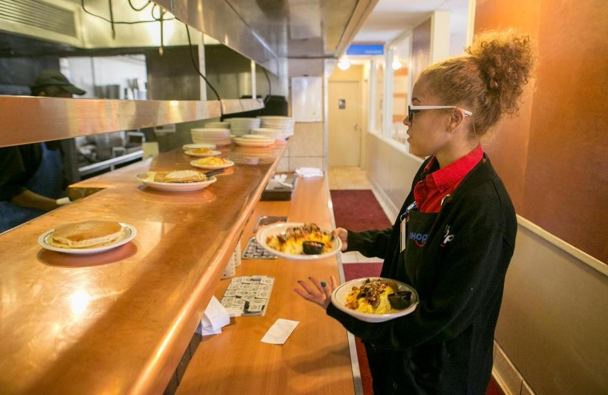 Waitress Tina Curda picks up her food for her customers inside the newly remodeled Belleville IHOP. Recent renovations included new plumbing, cabinets, pass bar, and seating area changes. The restuarant is also under new management.