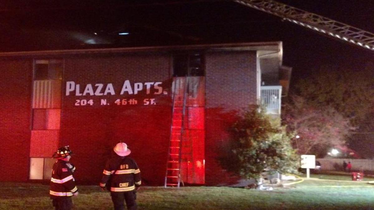 Belleville firefighters inspect the damage done to an apartment building on North 46th Street after a fire severely damaged it Wednesday night.