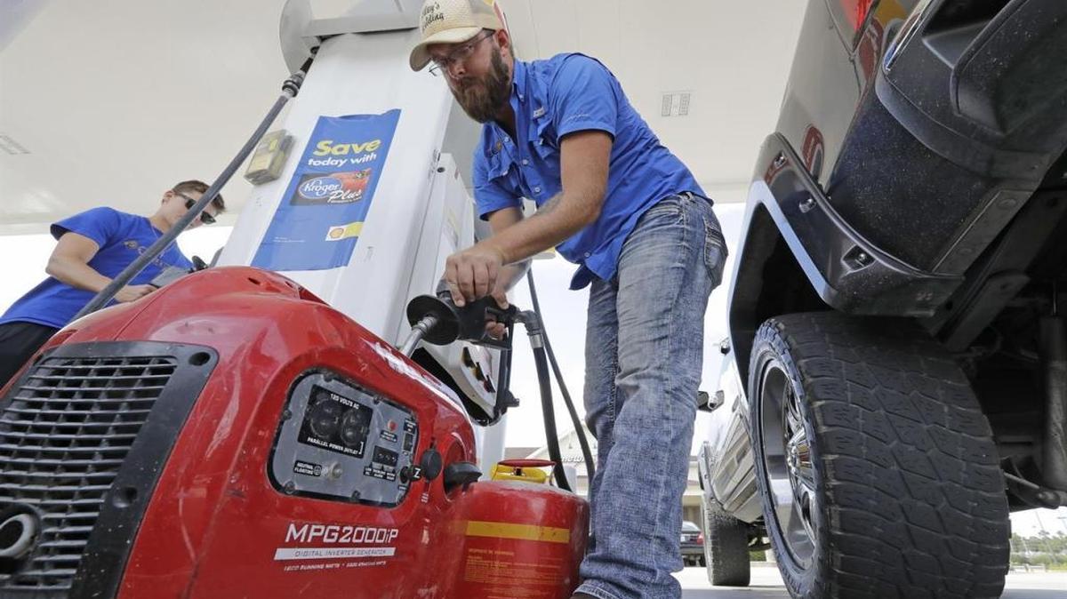 Aaron Berg fills up a gas can and his portable generator in Houston.