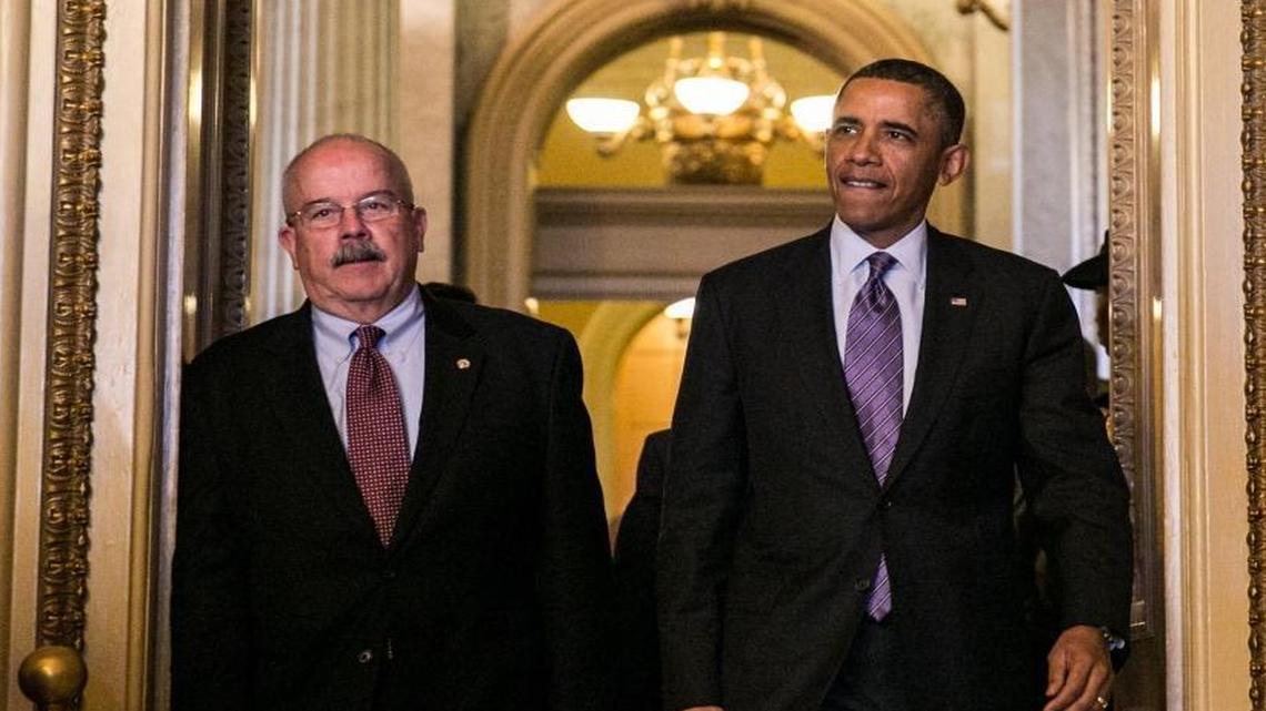 President Barack Obama, escorted by former U.S. Capitol Police Chief Terrance W. Gainer, arrives at the U.S. Capitol to meet with Senate Republicans on Capitol Hill in Washington, in 2013.