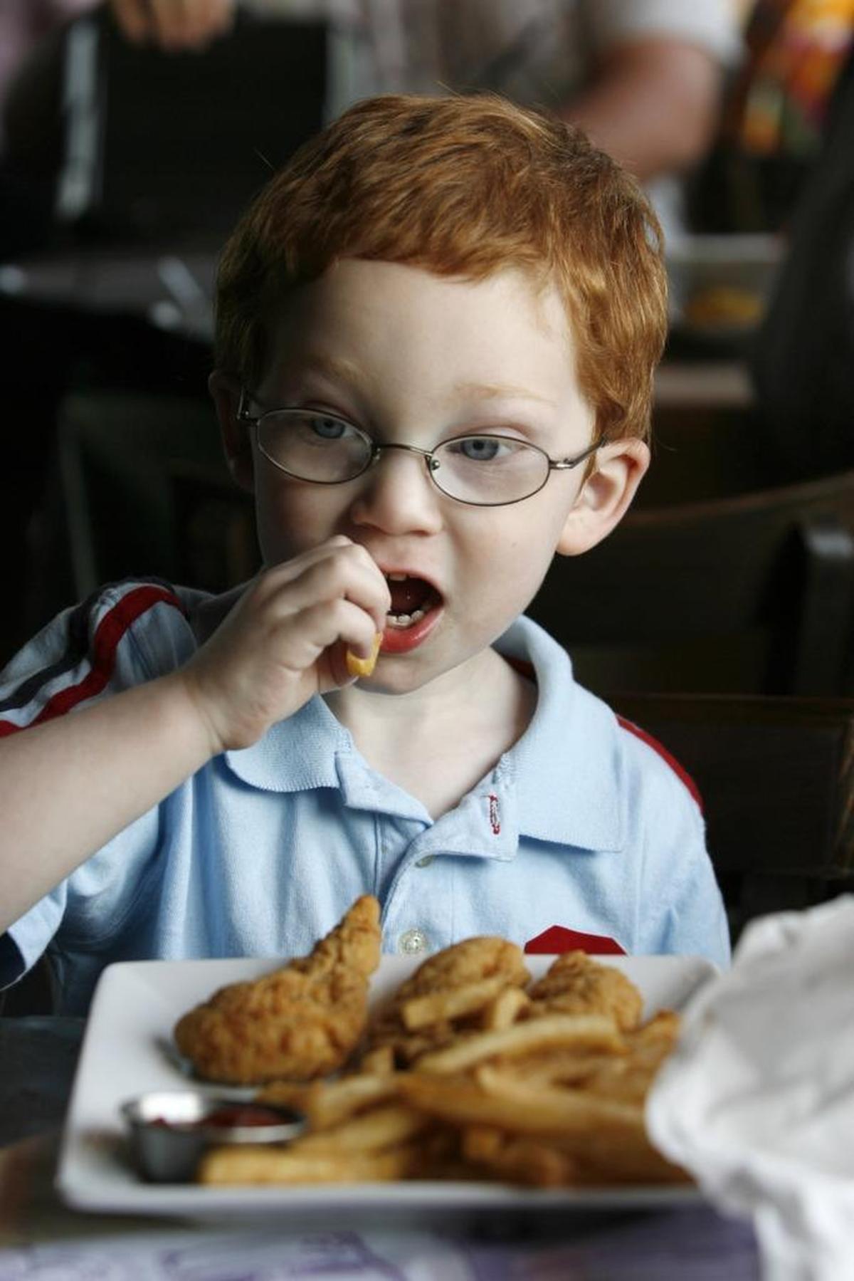 Jacob Frye, 3, has chicken strips and french fries for dinner at Ruby Tuesday. Ruby Tuesday offers free kids meals certain nights of the week with an adult purchase.