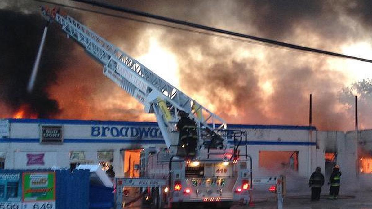 East St. Louis firefighters on May 17, 2014, fight the fire that consumed the Broadway Market at 15th and Broadway in East St. Louis. Firefighters and the city reached an agreement that cuts their numbers by attrition.