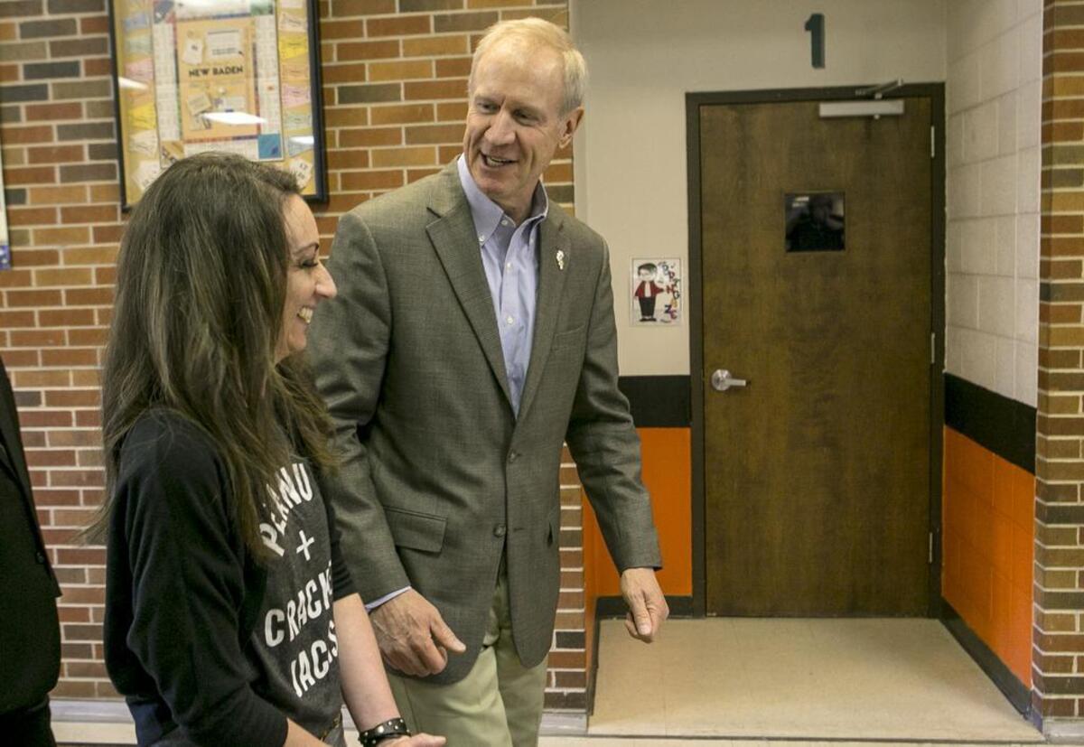 Gov. Bruce Rauner talks with New Baden Elementary School Kindergarten teacher Katie Mense, who made the winning class video.
