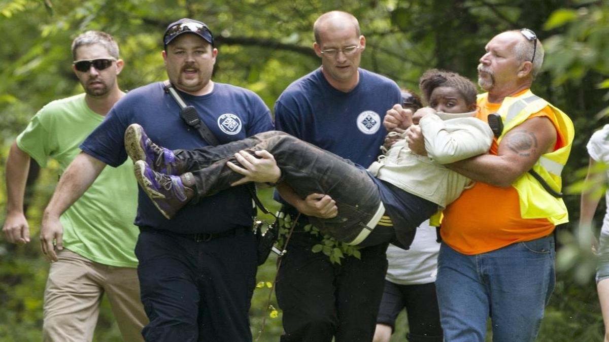 This photo by BND photographer Derik Holtmann won a first-place award in the Illinois Press Association awards competition. The photo depicts search-and-rescue workers carrying a 13-year-old girl who was found in a wooded area near Waterloo after she left a camp.