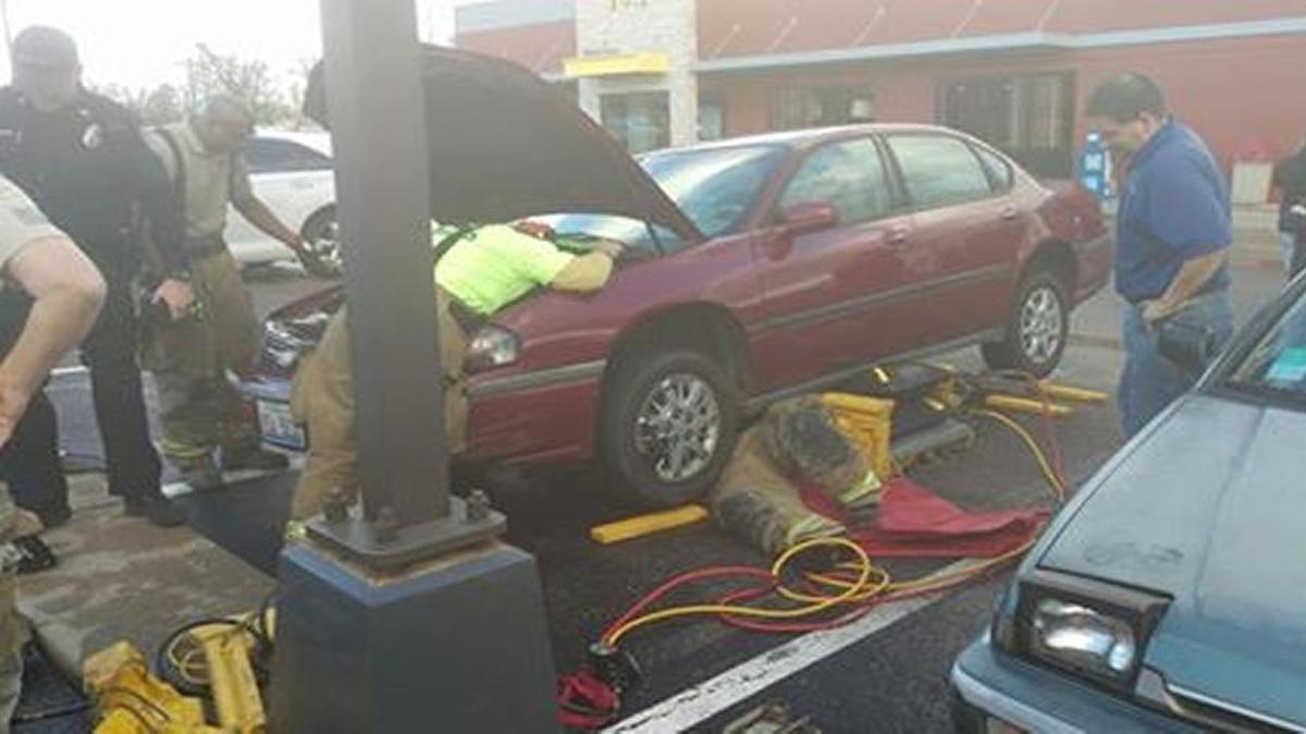 A member of the Swansea Fire Department saves a cat that had crawled into the engine of a parked car at McDonald’s, 2605 N. Illinois, on Tuesday afternoon. The cat, Toto, was not harmed after being stuck in the engine for a half hour.