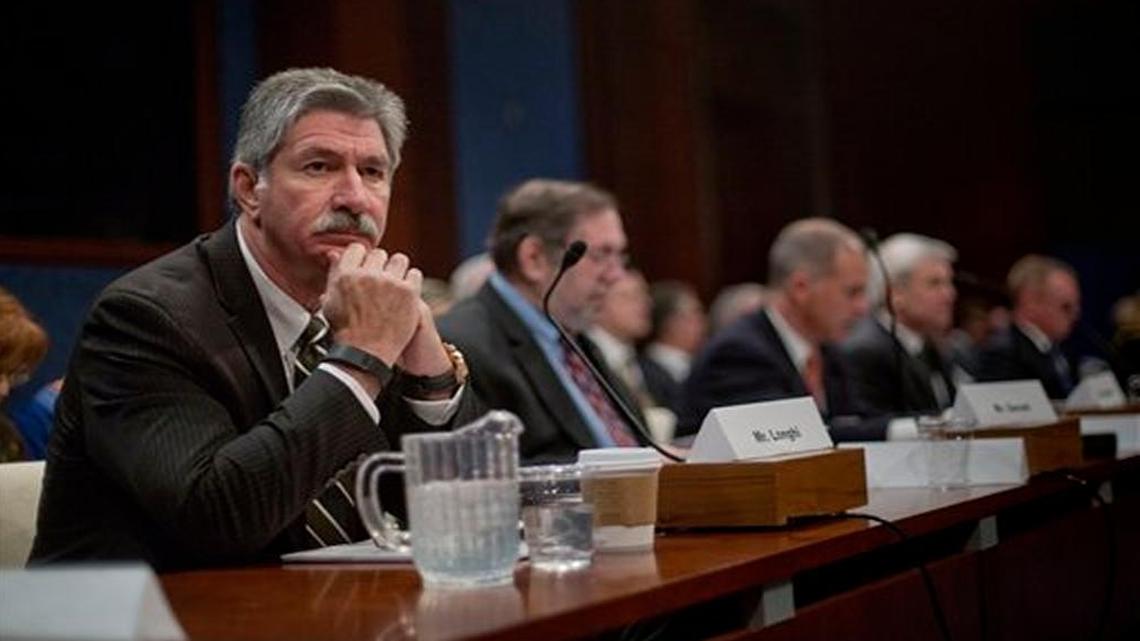 U.S. Steel President and CEO Mario Longhi, left, waits to speak on Capitol Hill in Washington, Thursday, April 14, 2016, during a hearing on the state of the U.S. steel industry. Longhi on Wednesday said he hopes to be able to recall laid-off steel workers soon.