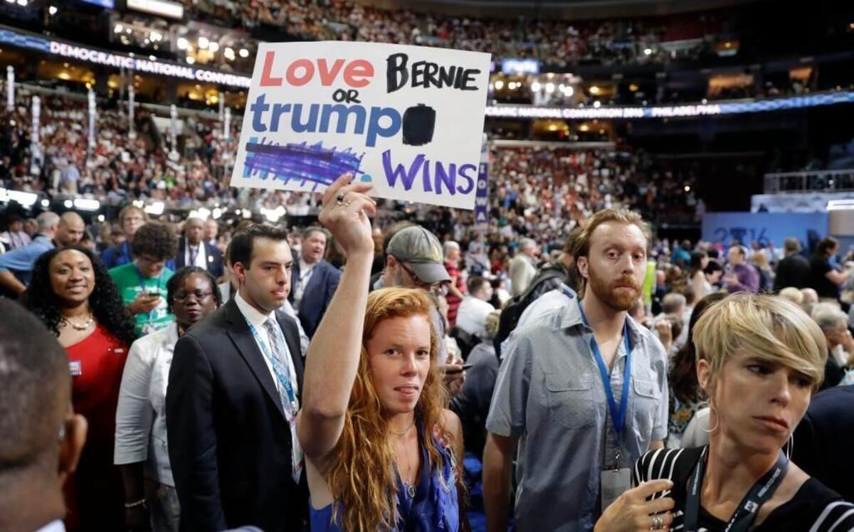 A supporter for former Democratic presidential candidate, Sen. Bernie Sanders, holds up a sign during the first day of the Democratic National Convention in Philadelphia on Monday.
