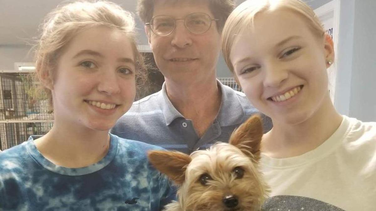 Ruth Prenzler (left), Madison County Board Chairman Kurt Prenzler and Katie Nosacka, pose with Mimi the Yorkie