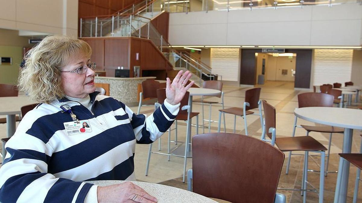 Su Gruenke in the lobby at Memorial Hospital East in Shiloh. Gruenke is the administrative assistant to hospital administrator Ruth Holmes.