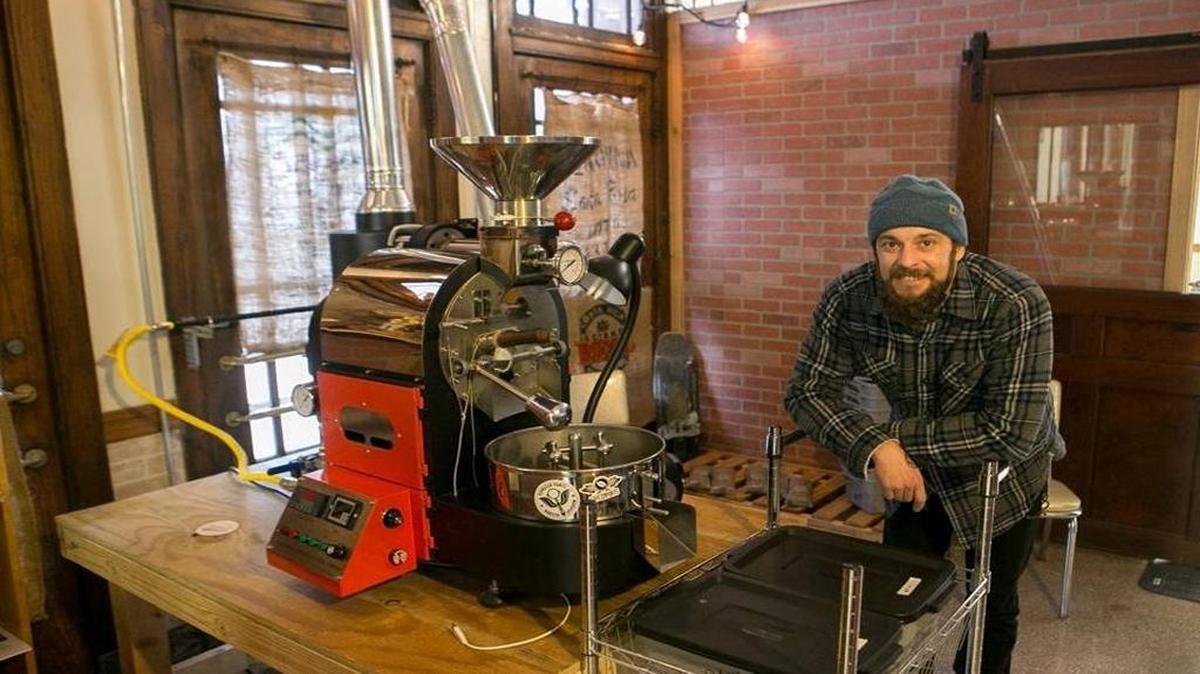 Owner and roaster Marshall Morris stands next to his coffee roaster inside Balance Coffee and Tea located in the old train depot on South Illinois Street in Belleville.