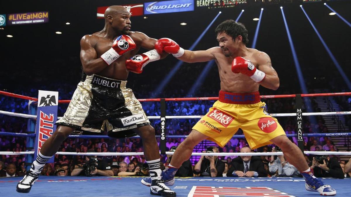 
Manny Pacquiao, right, from the Philippines, trades blows with Floyd Mayweather Jr. during their welterweight title fight on Saturday in Las Vegas.
