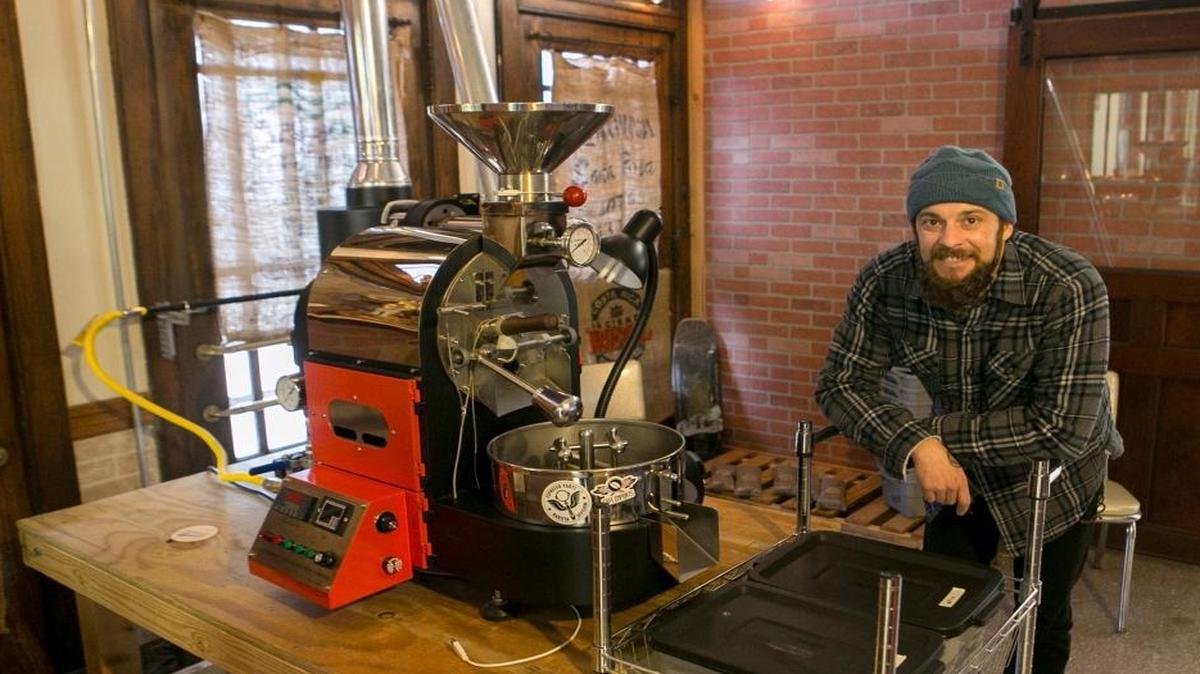 Owner and roaster Marshall Morris stands next to his coffee roaster inside Balance Coffee and Tea located in the old train depot on South Illinois St. in Belleville.
