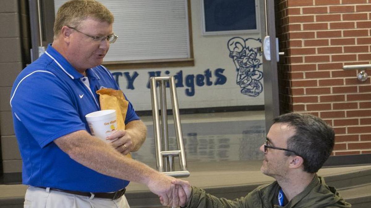 
Freeburg Superintendent Andrew Lehman shakes hands with Gary Arnold, president of Little People of America. Arnold and other members of LPA visited the school on Wednesday to present a petition urging Freeburg High School to change their school mascot.
