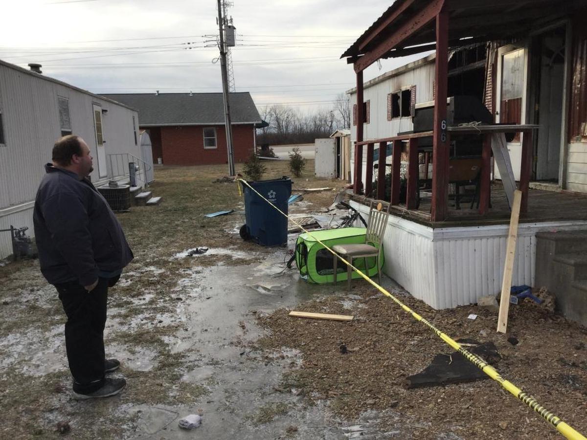 Dustin Neff looks at his burned home on Sunday.