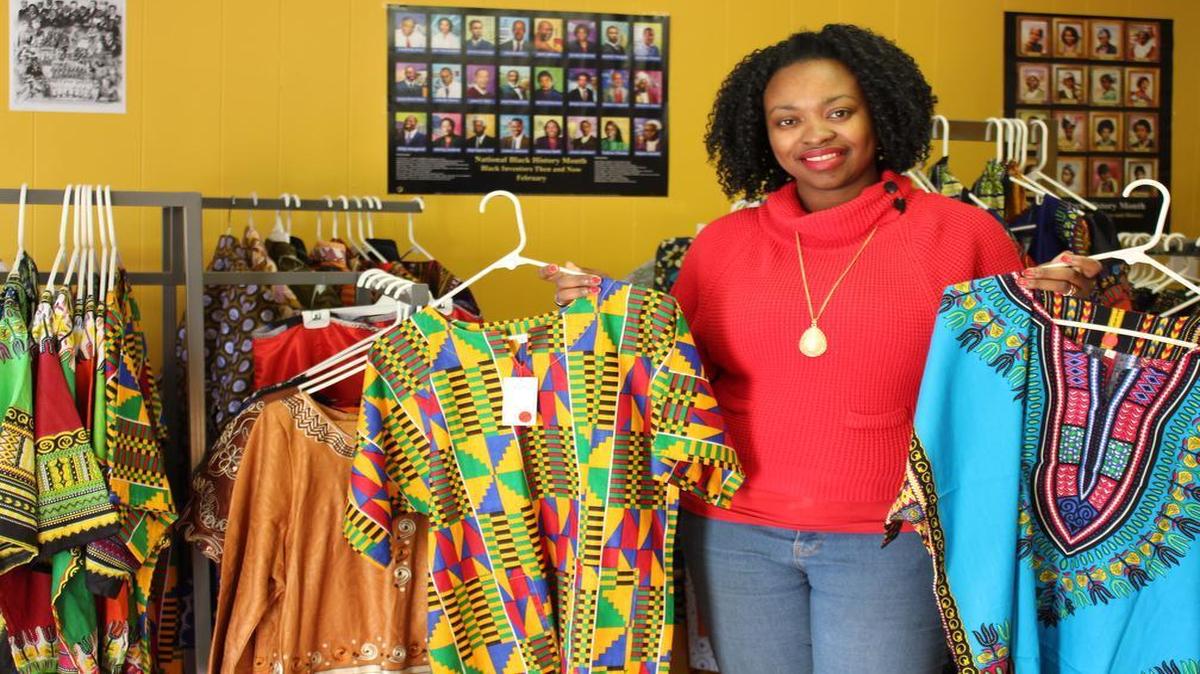 Owner Linda Faas shows off some of the colorful imported clothing she sells at Ogbah’s African Market in O’Fallon.