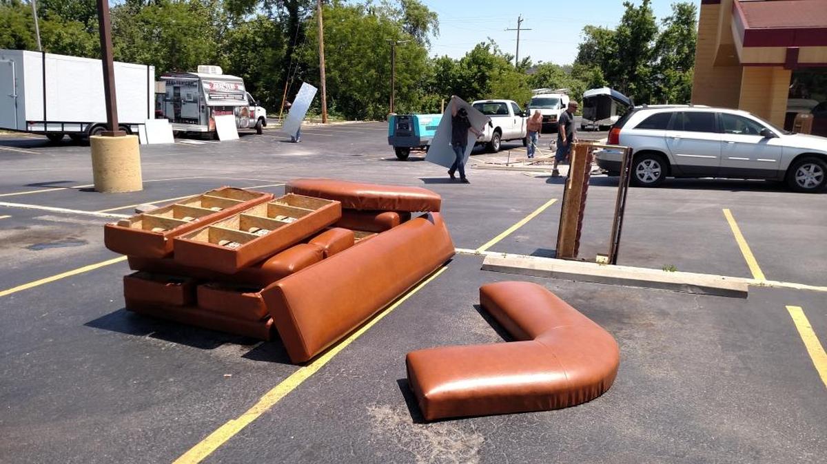 Parts of booths that once made up the interior of the Denny’s restaurant at 1130 S. Illinois St. in Belleville now are in piles in the parking lot as crews begin a renovation of the diner.