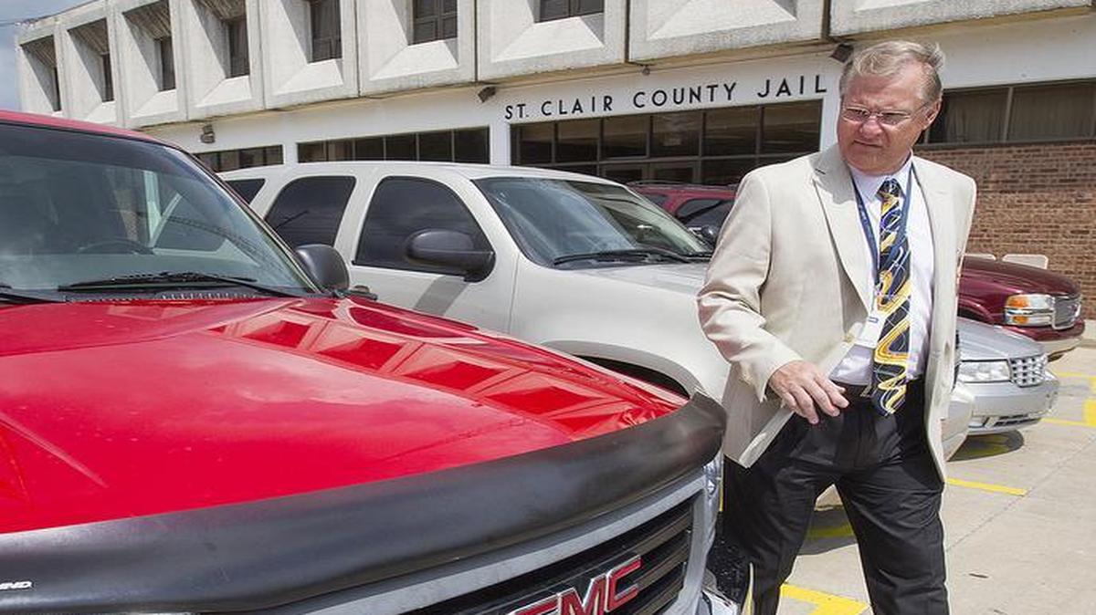 
St. Clair County Sheriff Rick Watson walks around a GMC Sierra pickup truck which is one of several cars, trucks and SUVs that have been seized from people caught in the commission of a crime. The vehicles, and other smaller items such as computers, will be auctioned off starting at 5 p.m. today at the Sheriff's Department, 700 N. Fifth St. in Belleville.
