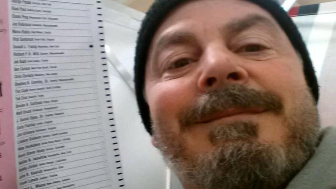 In this file photo, provided by Bill Phillips, of Nashua, N.H., Phillips takes a selfie with his marked election ballot. Ballot selfies, where people use smart-phones to photograph and share their marked ballots online, are becoming more common, as voters young and old look to share their views with family, friends and the world. But what they don't realize is they may be breaking the law, depending on where they live. Illinois law prohibits taking a photo of a marked ballot.