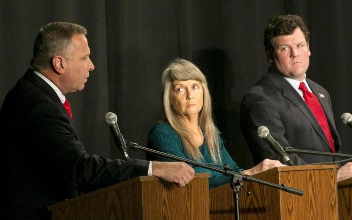 Incumbent Republican U.S. Rep. Mike Bost, left, answers a question as Green Party candidate Paula Bradshaw and Democratic candidate C.J. Baricevic listen during the 12th Congressional District debate held Thursday in Belleville.