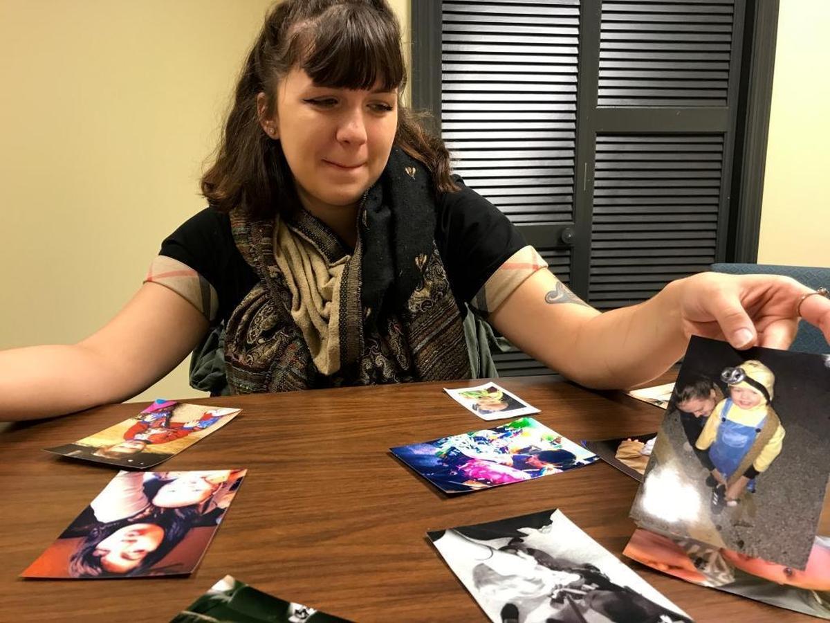 Lindsey Friess holds up photos of her two-year-old son Kane Friess-Wylie on Friday as she recalls the child’s short life.