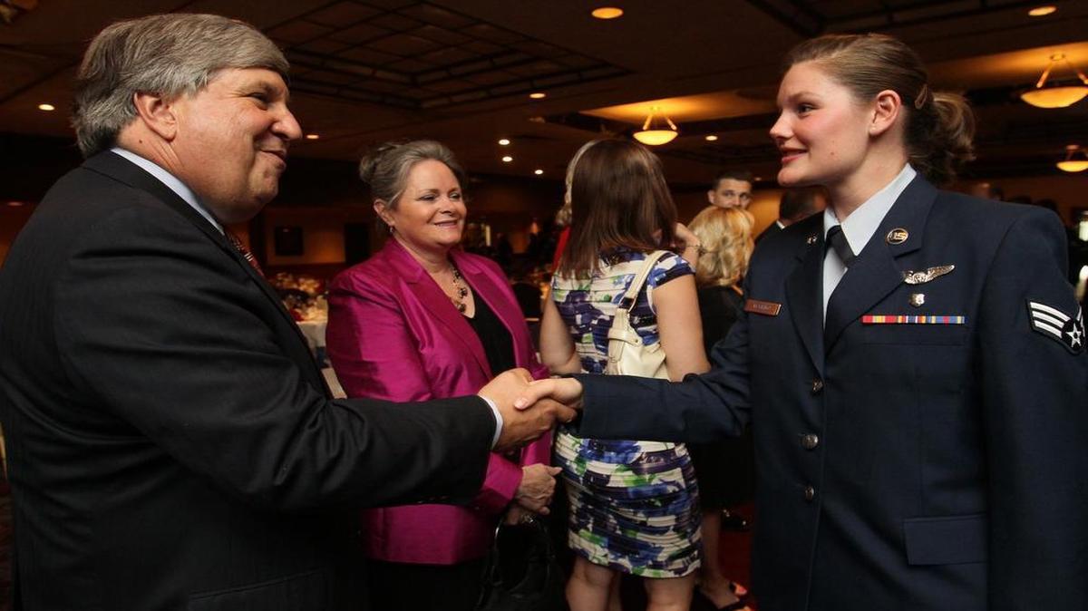 John Lengerman, executive director of the Belleville Chamber of Commerce, greets Senior Airman Emily Mormino of the 932nd A.E.S. at Scott Air Force Base at the 61st annual Belle-Scott Dinner at Fischer’s in Belleville in 2011.