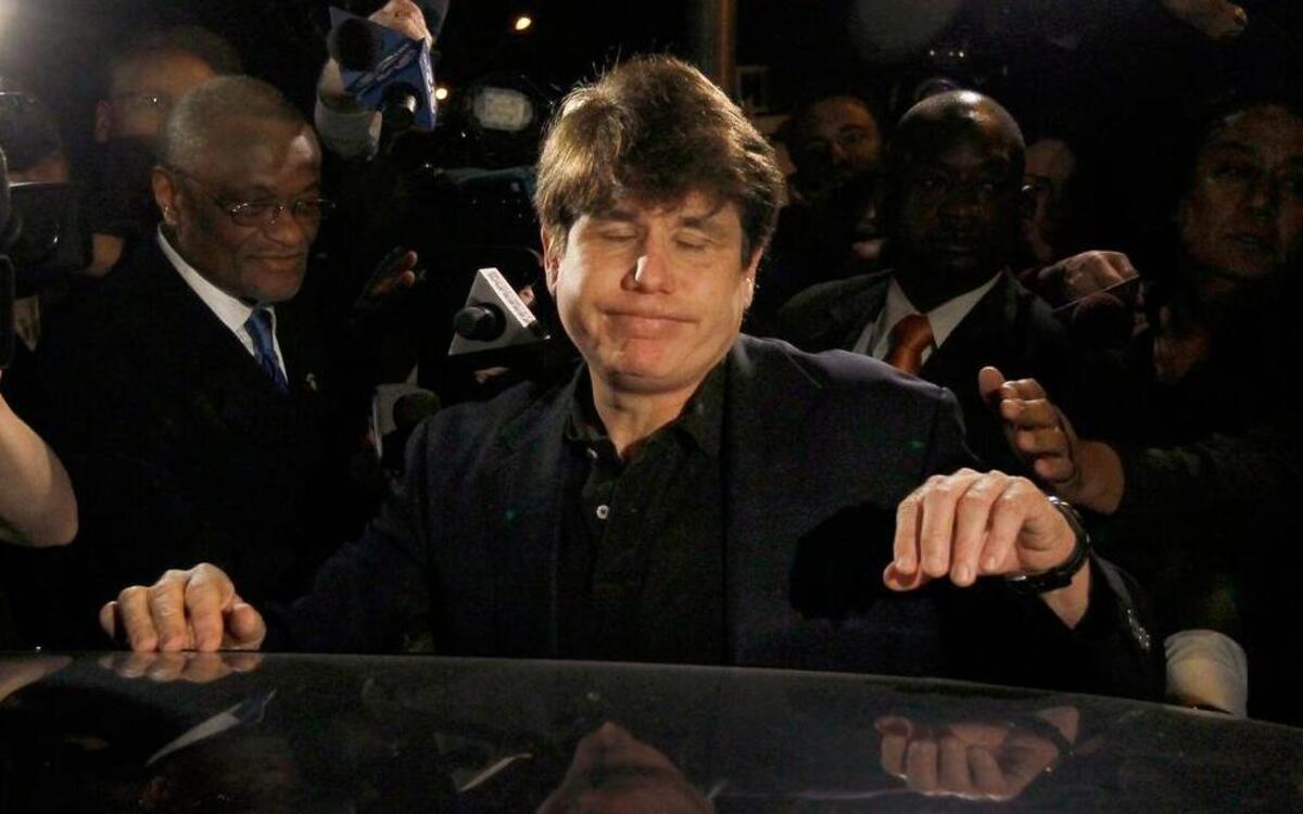 
Former Illinois Gov. Rod Blagojevich reacts as he departs his Chicago home for Littleton, Colo., to begin his 14-year prison sentence on corruption charges in March 2012. The 55-year-old Democrat was the second Illinois governor in a row to go to prison for corruption, but on Tuesday the 7th U.S. Circuit Court of Appeals in Chicago threw out some of the convictions.

