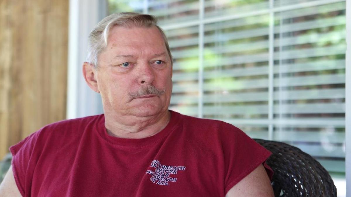 Dave Shreve, 73, used bolt cutters to remove a padlock to a switch that controls outdoor municipal lighting at the village park.