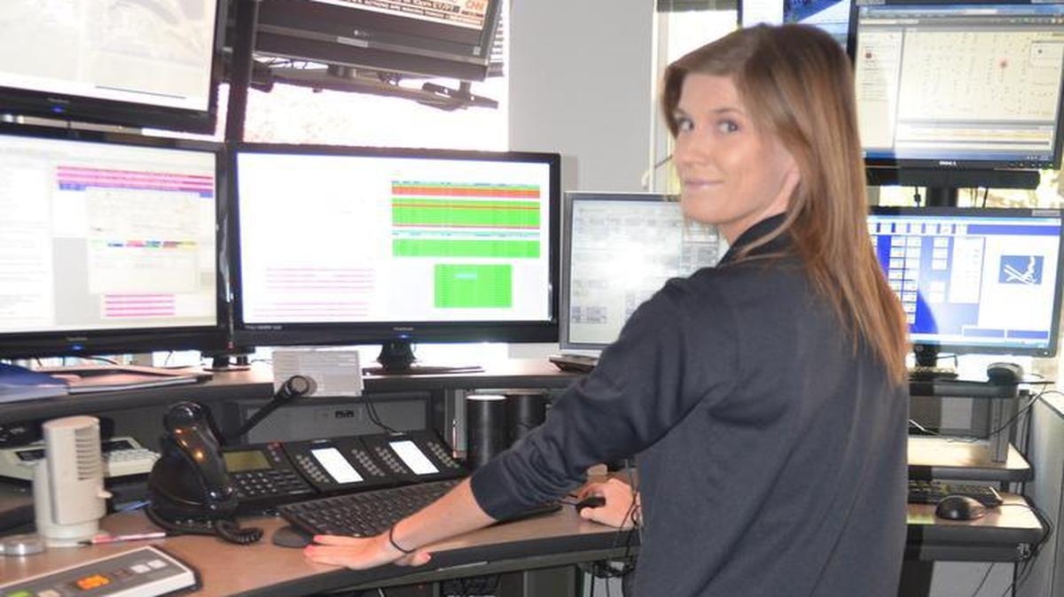 O’Fallon Public Safety telecommunicator Carmen Kuhl clocks extra miles on the department’s stationary bicycle while working her shift in this April 2016 file photo.