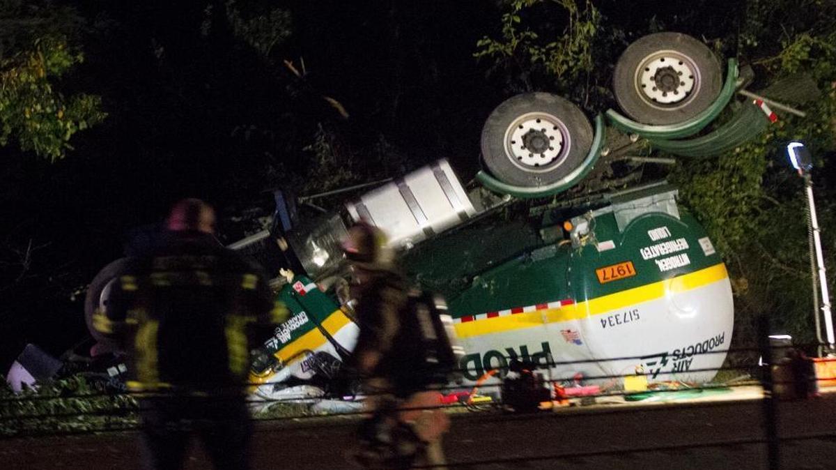 
A tanker truck that overturned Thursday night on I-64 near Scott Air Force Base rests upside down in the area north of the highway. The driver, Kevin Ryan, 62, of St. Louis, was killed in the crash.
