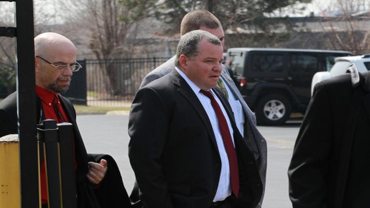 Former St. Clair County Judge Mike Cook walks from the federal courthouse to a waiting car after his sentencing in 2014.