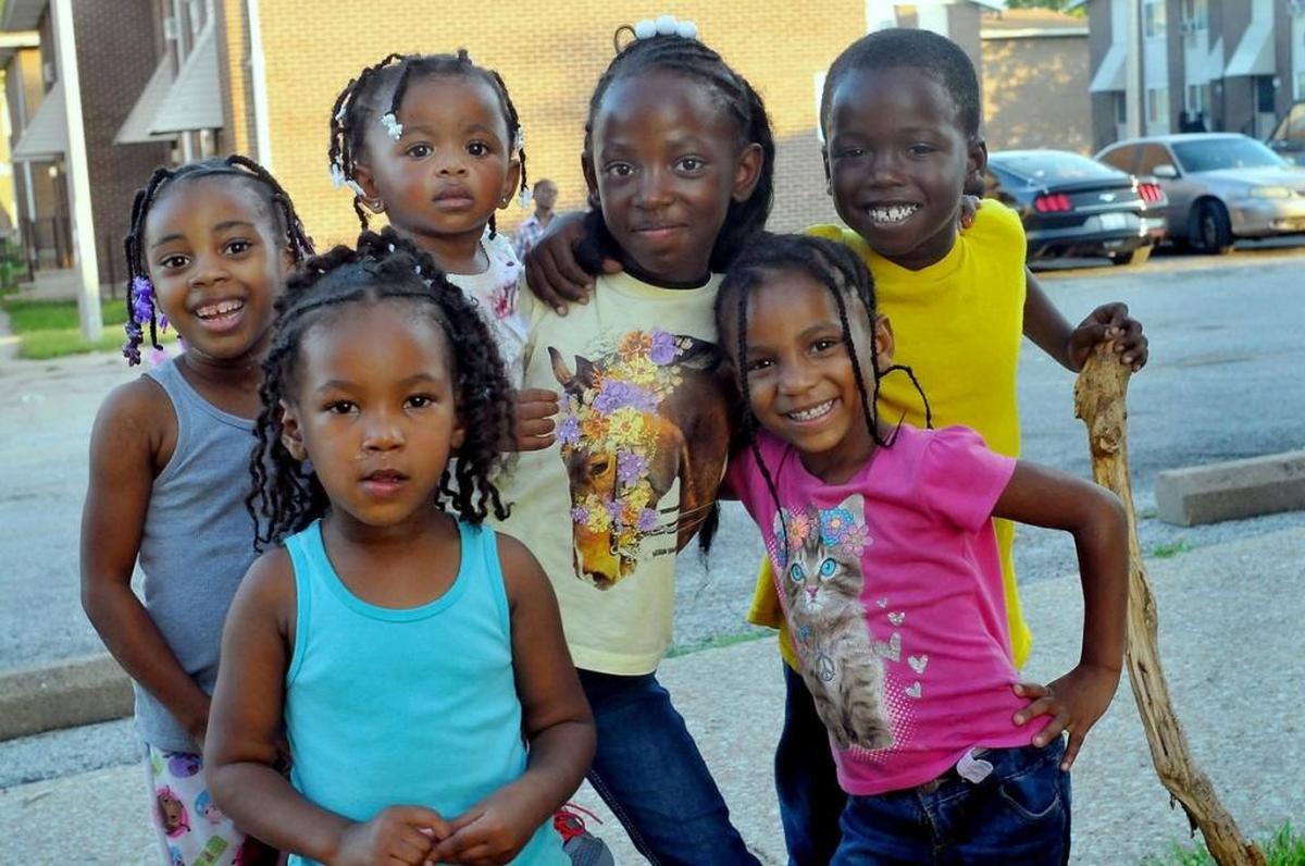 Children pose outside their public housing in East St. Louis.