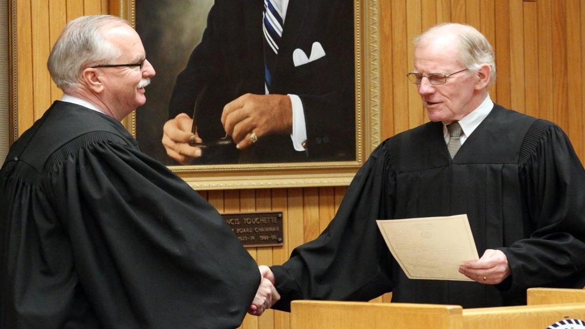 St. Clair County Circuit Judge Vince Lopinot, left, shakes hands with Chief Judge John Baricevic. Baricevic is one of three judges running for election rather than retention.