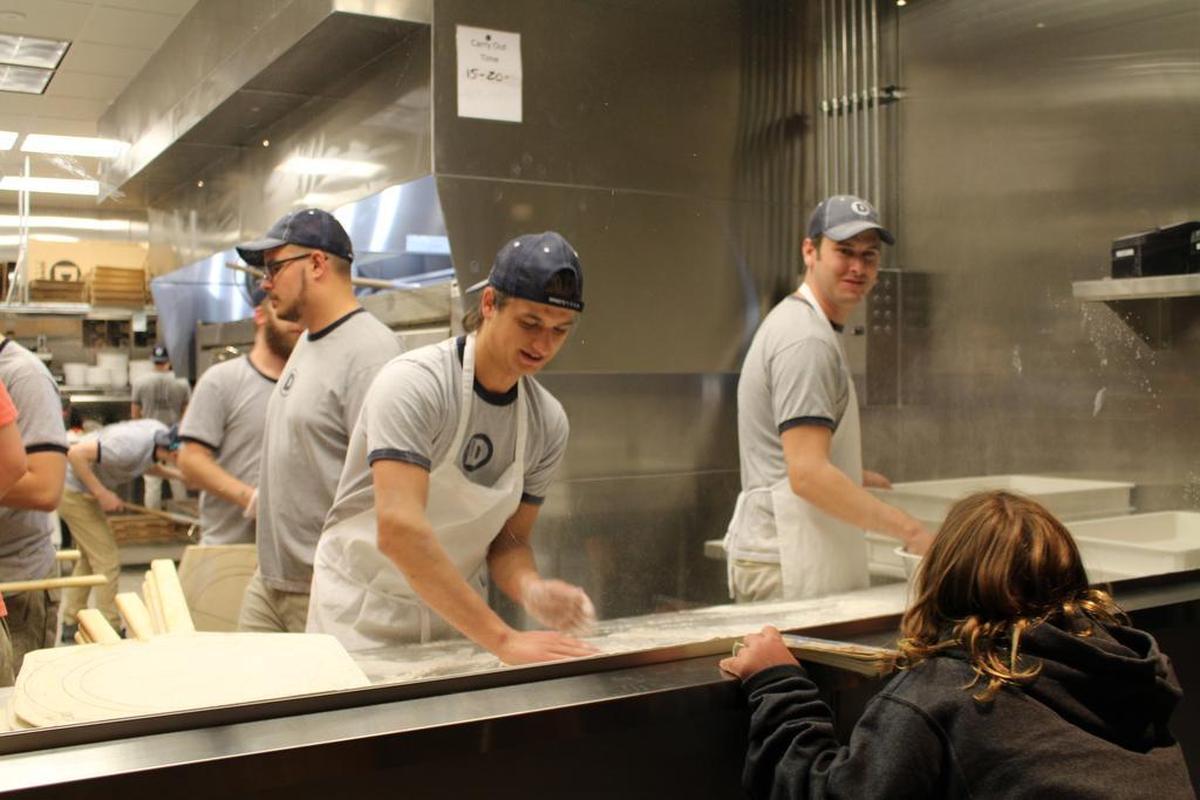 The new Dewey’s Pizza restaurant in O’Fallon has the company’s trademark kitchen window, allowing customers to see cooks rolling out dough, throwing it in the air and adding fresh ingredients.