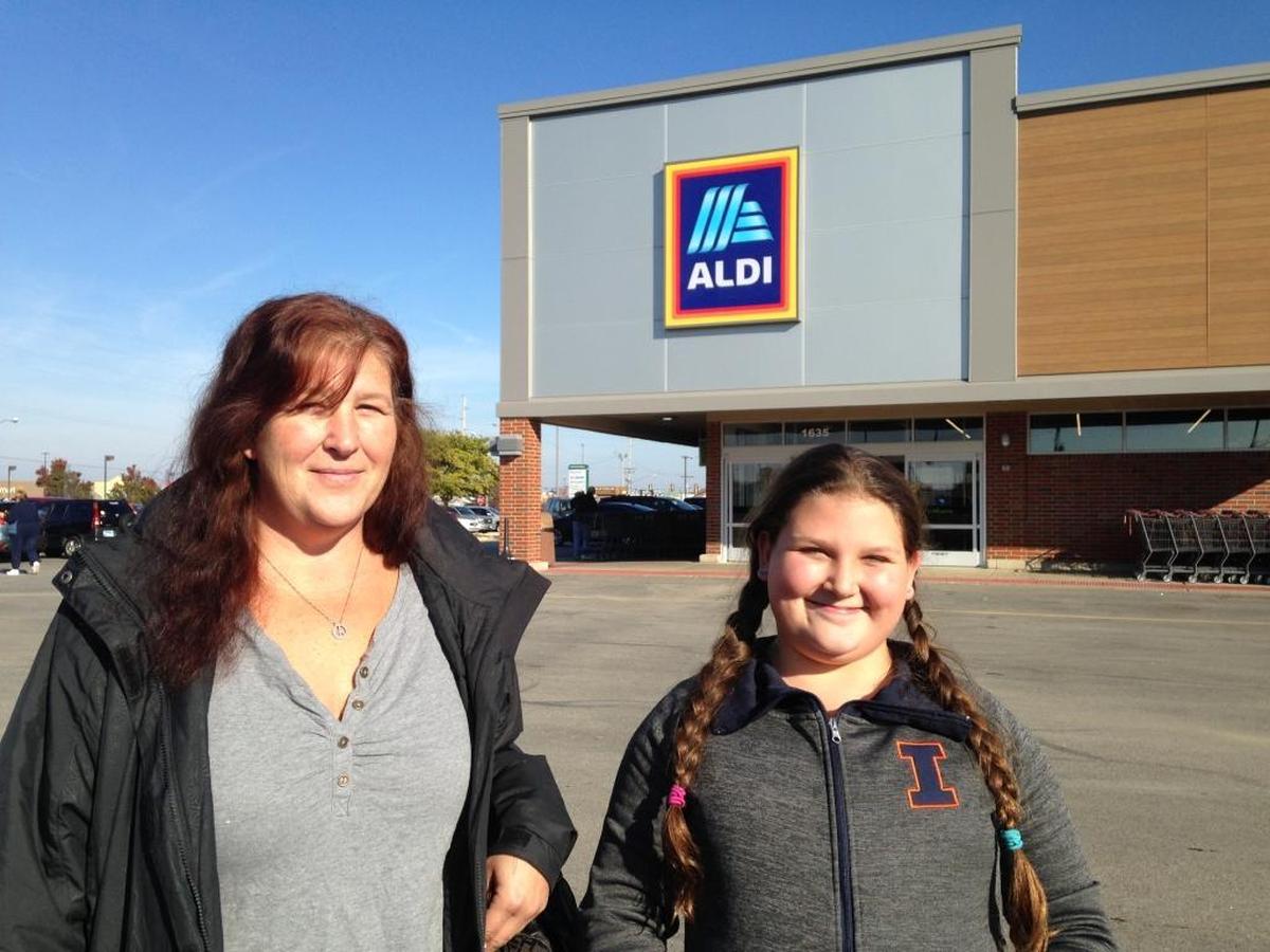 Kindra Bell, left, of Fairview Heights, and her daughter, Maelynn Procasky, 11, were among shoppers at the newly remodeled Aldi store in O’Fallon on opening day.