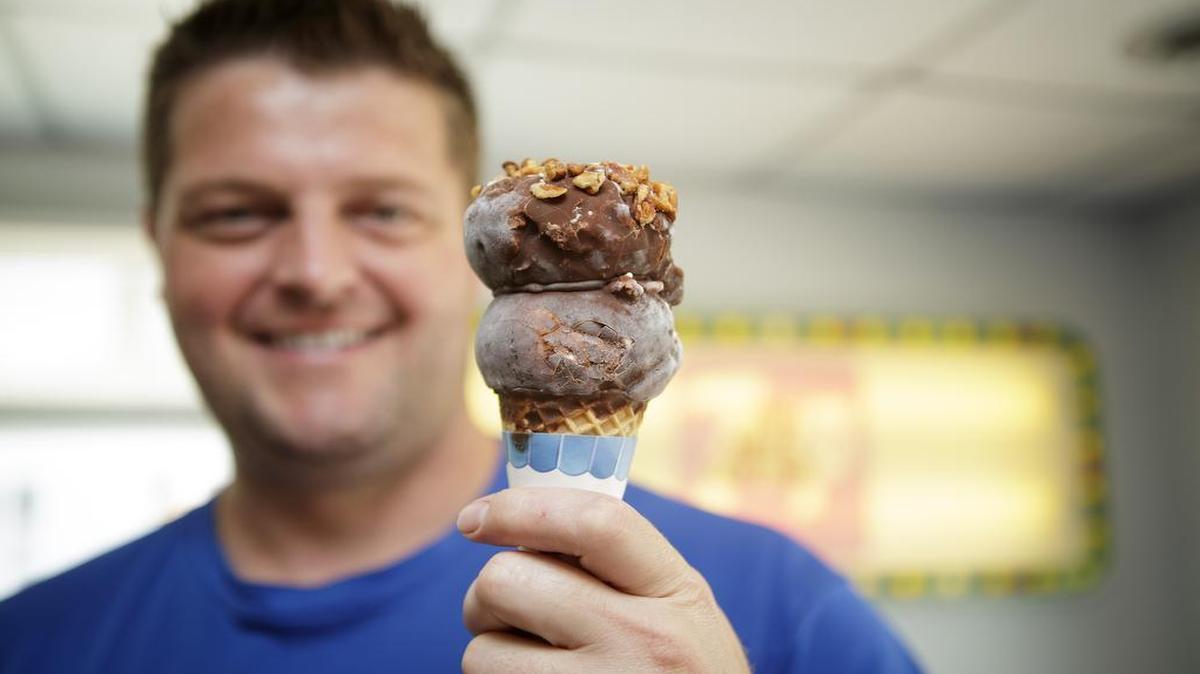 White Cottage owner Chris Cordie holds an ice cream cone in this file photo.