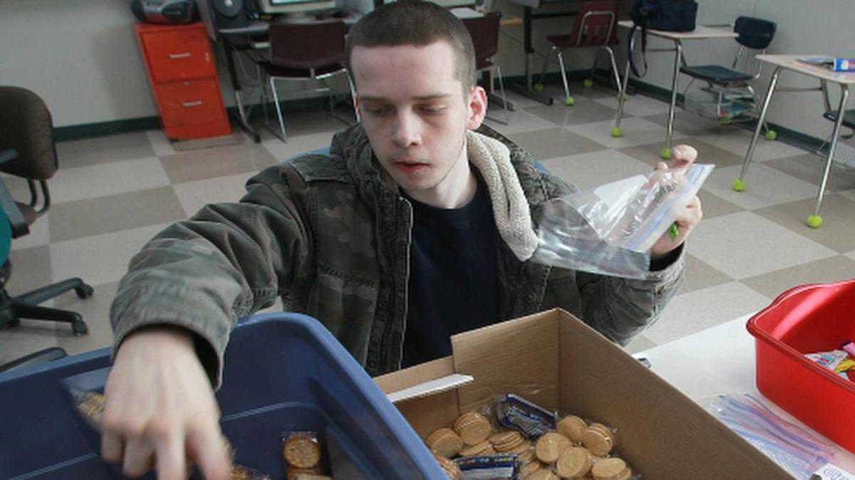 
Cody Smith, 20, from Belleville, helps sort food items to be sent to troops as part of Help for Heroes earlier this year. Cody is a student at Pathways School in Belleville, operated by BASSC.
