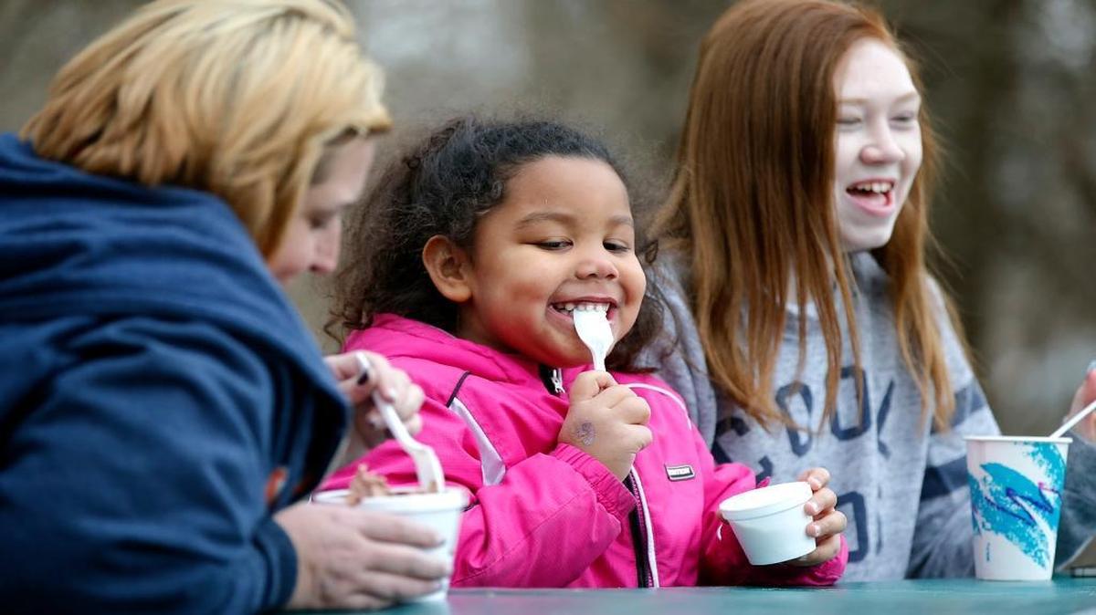 Nicole Bova (from left) and her daughters Aubreyana Scruggs, 5 and Trisha Kite dig into their ice cream Wednesday at Dairy Haven in Caseyville. The Caseyville residents started making a trip for ice cream a near-daily stop last summer and now “We have to come here every day,” said Bova.