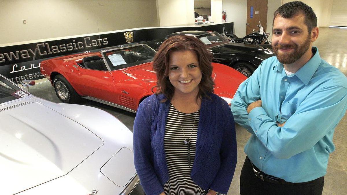 
John Busch, events coordinator for Gateway Classic Cars, stands with Sarah Boothby, Public Relations for the firm, in front of three classic Corvettes on display inside the immense showroom. The business is beginning to allow parties inside their store. 
