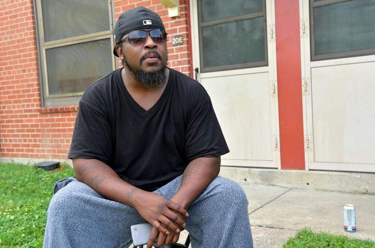 Keneth Hayes Jr. sits outside his apartment at the John DeShields Housing Complex.