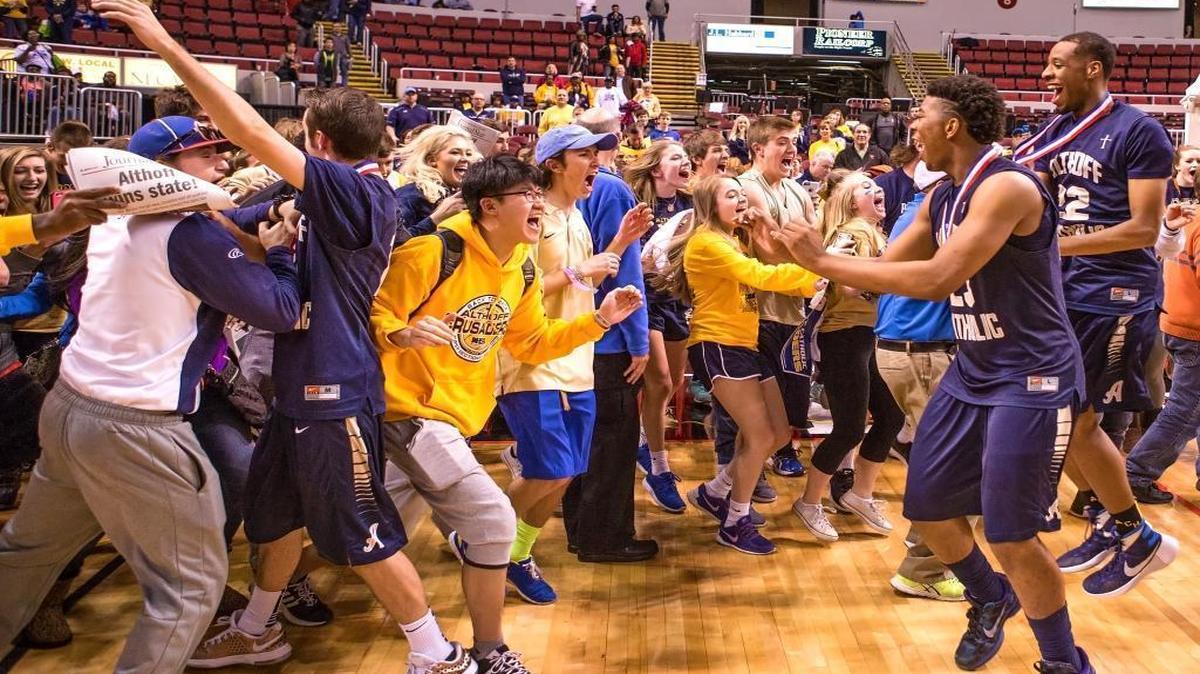 Althoff players and fans celebrate after the Crusaders’ state title win Saturday in Peoria