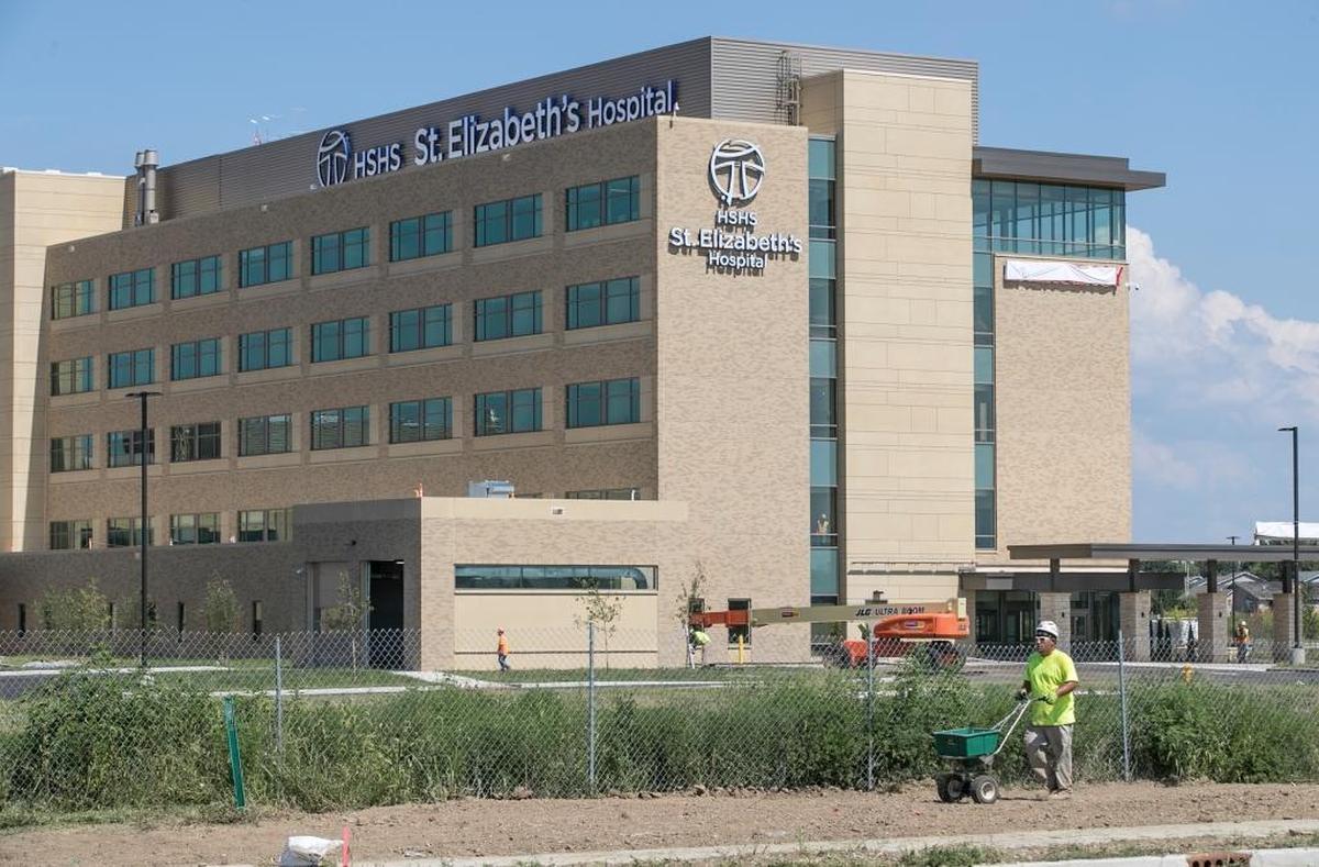 A worker sows grass outside the new St. Elizabeth’s Hospital in O’Fallon. The replacement hospital is expected to open on Nov. 4. Substantial construction is now complete with hospital officials expected to receive the “keys” to the new building during a ceremony on Thursday August 10th.