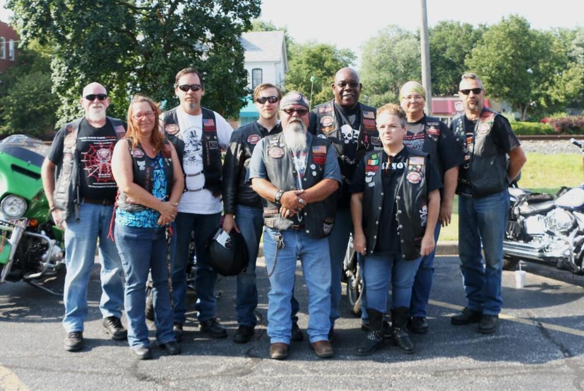 Members of the Metro-East Chapter of Bikers Against Child Abuse pose in front of their bikes outside the VFW Post 805 in O’Fallon.