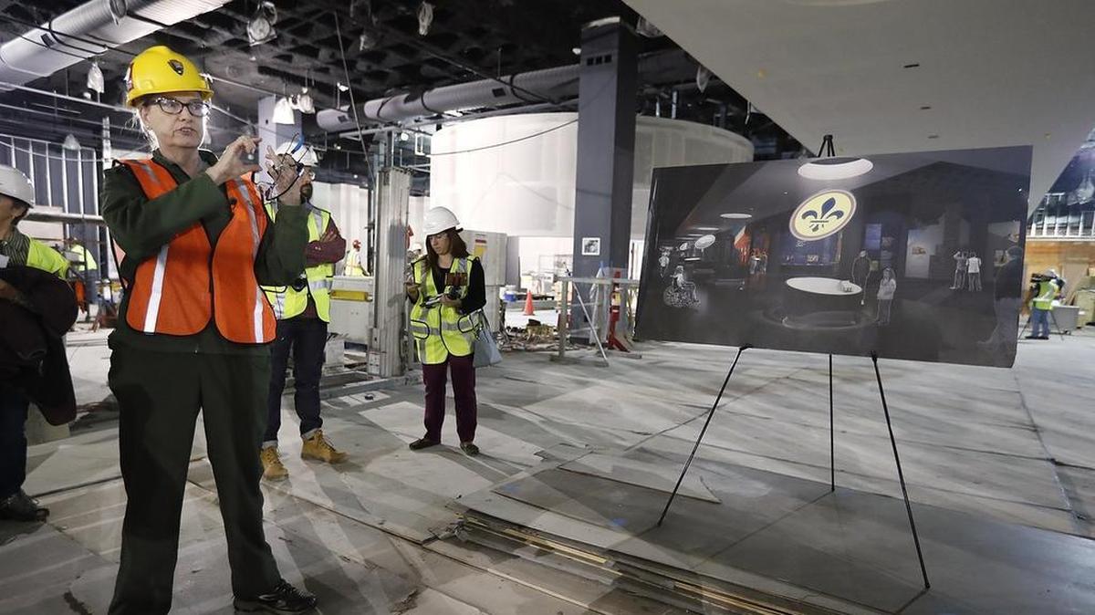 Chief of museum services Rhonda Schier guides a tour through one of the exhibit areas being renovated at the Gateway Arch museum and visitor center.