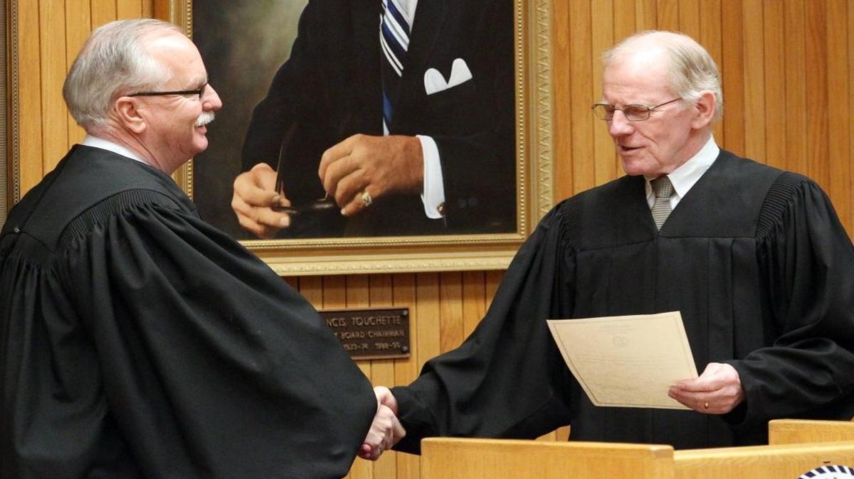 St. Clair County Circuit Judge Vince Lopinot, left, shakes hands with Chief Judge John Baricevic. Baricevic is one of three judges running for election rather than retention.