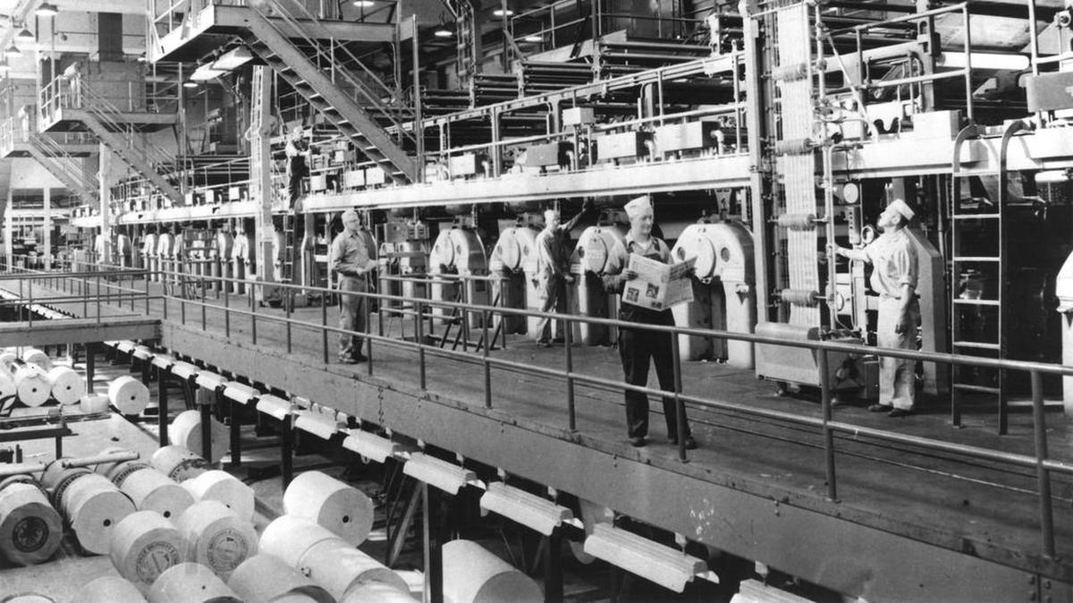 Inside the Chicago Sun-Times production room in 1960, pressmen check the quality of the printed product.