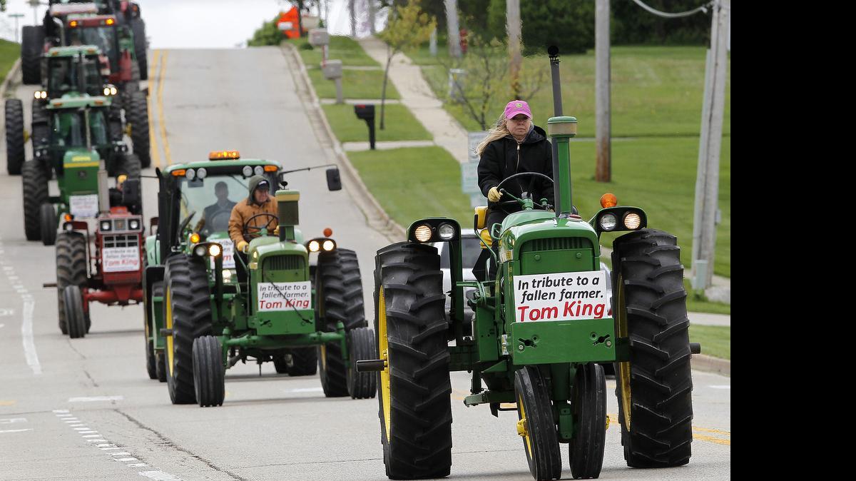 
Candace Stade of McHenry, travels north on South Green Street along with other farmers on tractors in the funeral procession for McHenry farmer Tom King on Tuesday in McHenry. 
