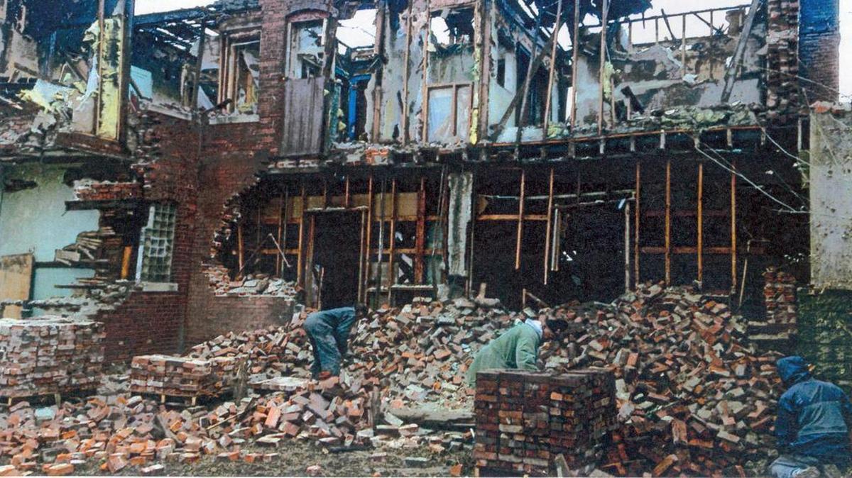 Workers during November 2014 harvest bricks from a burned building in the 600 block of St. Louis Avenue in East St. Louis.