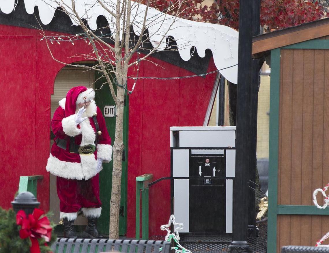 Santa waves to workers and shoppers at the Christkindlmarkt on Belleville’s Public Square.