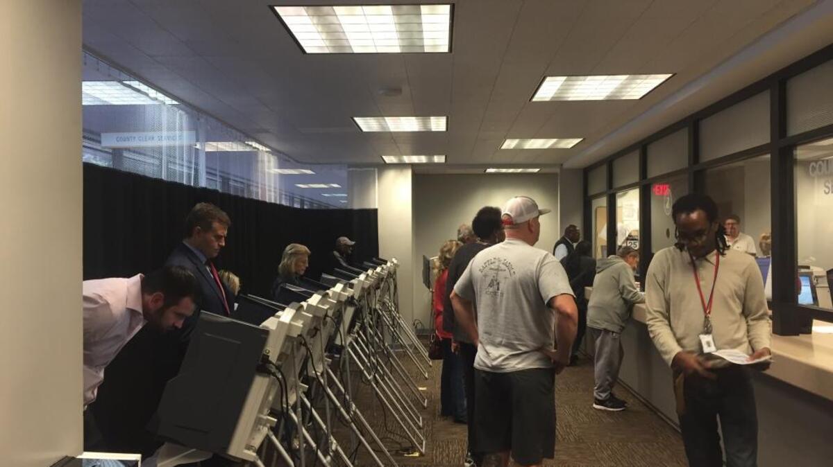 Voters at the St. Clair County Courthouse in Belleville on Tuesday use touch screens to vote early in the Nov. 8 General Election. More than 3,000 people have voted early in St. Clair County so far.
